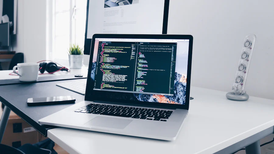 A laptop on a desk showing website code in an editor
