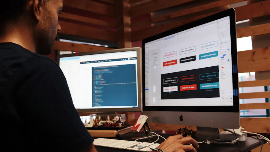 A designer working on website interface layouts on a large monitor with code open on a second screen